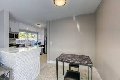 a kitchen with a counter and a table in a room at Sunshine Manors 2025-A in Fort Lauderdale