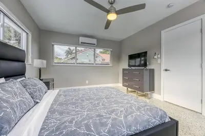 a bedroom with a bed and a flat screen tv at Sunshine Manors 2025-A in Fort Lauderdale