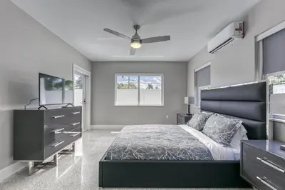 a bedroom with a bed and a dresser and a television at Sunshine Manors 2009 A in Fort Lauderdale