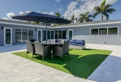 a patio with a table and chairs and an umbrella at Sunshine Manors 2013 B in Fort Lauderdale