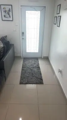 a room with a door with a rug in front of it at BOOK ME, 3mins Hard Rock Stadium in Miami Gardens