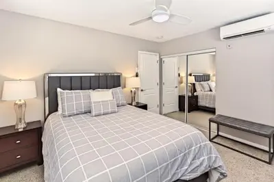 a bedroom with a large bed with a ceiling fan at Wiltonplex Complex in Fort Lauderdale