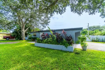 a house with a yard with green grass at Stunning Hollywood Pool Home in Hollywood