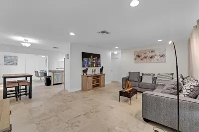 a living room with a couch and a table at Stunning Hollywood Pool Home in Hollywood