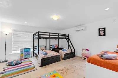 a bedroom with two beds and a large mirror at Stunning Hollywood Pool Home in Hollywood