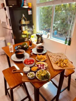 a table with plates of food on it in a kitchen at Beach vibes 2 bedrooms house in Miami