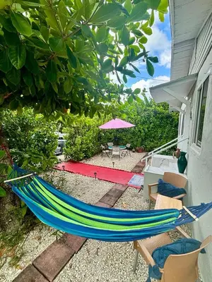 a hammock sitting on the side of a house at Beach vibes 2 bedrooms house in Miami