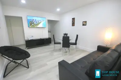 a living room with a couch and a table with chairs at 251 Airport/Top House Apartments in Miami