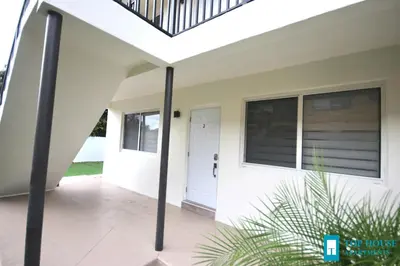 a front porch of a house with a white door at 251 Airport/Top House Apartments in Miami