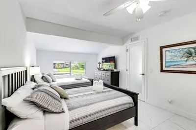 a bedroom with two beds and a ceiling fan at 5BD House - Pool+BBQ+King beds - 3 min to beach in Hollywood