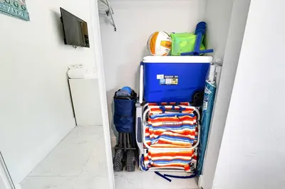 a room with a shelf with towels and a refrigerator at 5BD House - Pool+BBQ+King beds - 3 min to beach in Hollywood