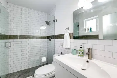a white bathroom with a toilet and a sink at 5BD House - Pool+BBQ+King beds - 3 min to beach in Hollywood