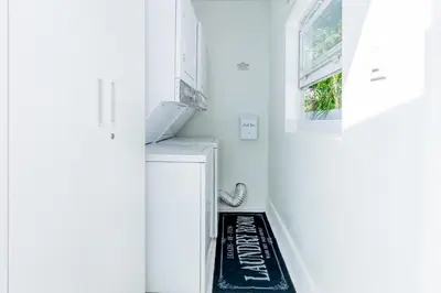 a hallway with a staircase with a rug on the floor at Serenity Lodge Condo in Miami