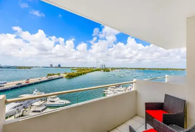a balcony with a view of a marina with boats at Waterfront Studio Condo in the Heart of Miami - Skyline & Bay Views in Miami Beach