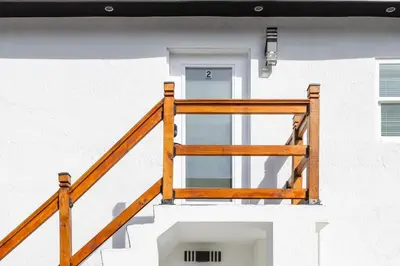a wooden railing on the side of a building at Serenity Lodge II Condo in Miami