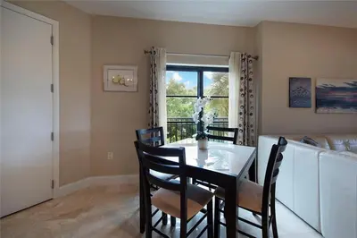 a dining room with a table and chairs and a window at 2/2 Boutique Condo in Ft. Lauderdale in Fort Lauderdale