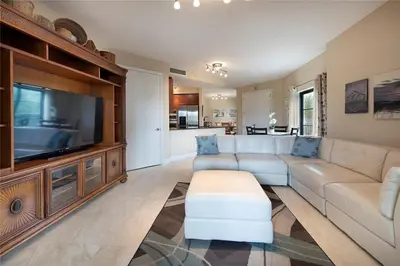 a living room with a couch and a large television at 2/2 Boutique Condo in Ft. Lauderdale in Fort Lauderdale