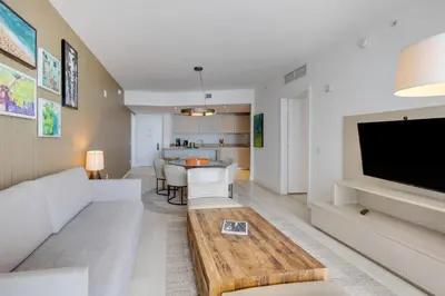 a living room with a couch and a table at 18th Floor Ocean Views Pool Beach Fitness in Hallandale Beach
