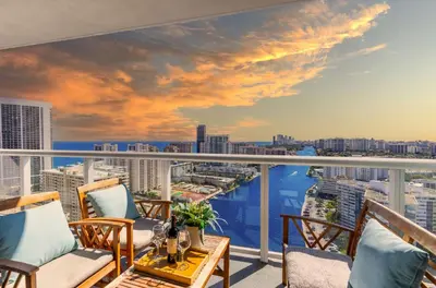 a balcony with chairs and a view of the city at Near Beach - Pool - Infinity View - Balcony - Gym in Hallandale Beach