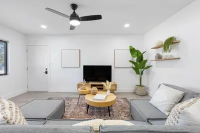 a living room with a couch and a tv at Sun Getaway Rentals in Fort Lauderdale