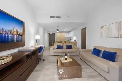 a living room with a couch and a tv at Amazing Pool - Hot Tub - Hollywood Beach Haven in Hollywood