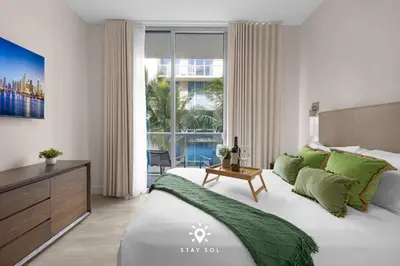 a bedroom with a large bed and a large window at Amazing Pool - Hot Tub - Hollywood Beach Haven in Hollywood