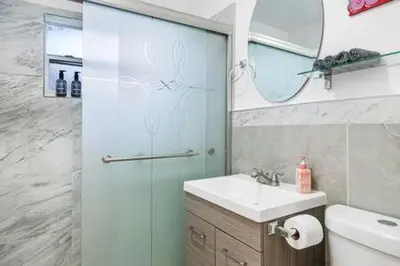 a bathroom with a shower and a sink and a mirror at Huge 1 bed newly renovated free parking in Miami