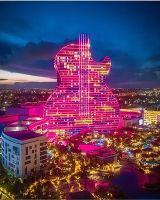 a building with a guitar lit up at night at Huge 1 bed newly renovated free parking in Miami