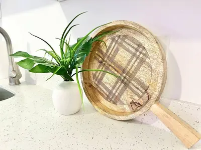 a wooden fan sitting next to a vase with a plant at Boho 6, studio Near Air-Cruise Port & Beach in Fort Lauderdale
