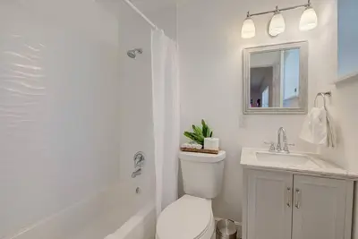 a white bathroom with a toilet and a sink at Boho 6, studio Near Air-Cruise Port & Beach in Fort Lauderdale