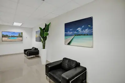 a waiting room with two chairs and a painting on the wall at Ocean Reserve Condominium in Miami Beach