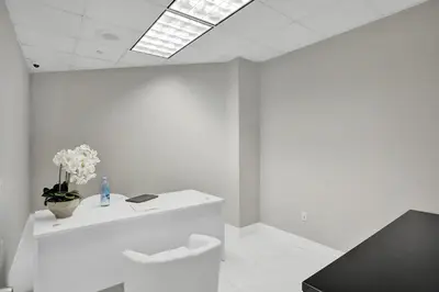 a white room with a toilet and flowers on it at Ocean Reserve Condominium in Miami Beach