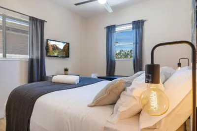 a bedroom with a large bed and a window at Azure - Mins to Las Olas & Beach in Fort Lauderdale