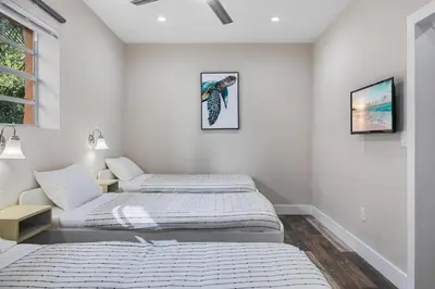 a bedroom with two beds and a window at Lauderdale Bliss - Mins to Las Olas & Beach in Fort Lauderdale