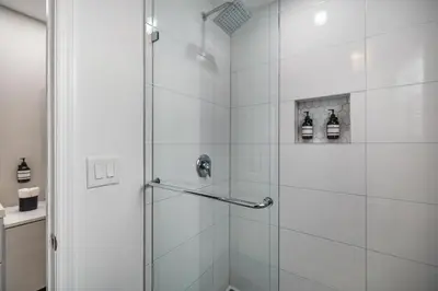 a bathroom with a shower with a glass door at Lauderdale Bliss - Mins to Las Olas & Beach in Fort Lauderdale