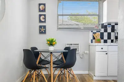 a kitchen with a table and chairs in a kitchen at Seascape - Mins to Las Olas & Beach in Fort Lauderdale
