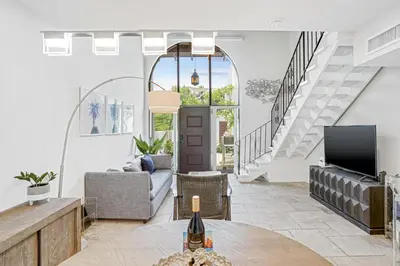 a living room with a table and a tv at Luxury Pool Villa at St. James UNIT E, Pet Friendly in Miami