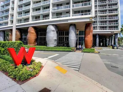 a large building with a red sign in front of it at ICON W BRICKELL BY IMD MIAMI Elegant River View 1BR 1BA in Miami