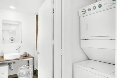 a white kitchen with a sink and a refrigerator at ICON W BRICKELL BY IMD MIAMI Elegant River View 1BR 1BA in Miami