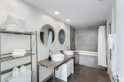 a bathroom with two sinks and a tub at ICON W BRICKELL BY IMD MIAMI Elegant River View 1BR 1BA in Miami