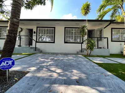 a house with a sign in front of it at Stylish 3/2 centrally located! in Miami