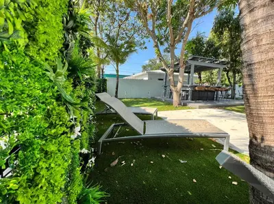 a bench sitting in a yard next to a bush at Stylish 2/1 centrally located! in Miami