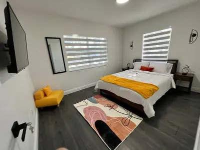 a bedroom with a large bed and a rug at Stylish 2/1 centrally located! in Miami