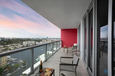 a balcony with chairs and a view of the city at Amazing view - Balcony - Gym - Pool in Hallandale Beach