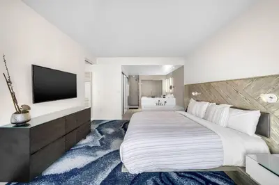 a bedroom with a large bed and a television at W FT LAUDERDALE RESIDENCES BY IMD MIAMI Stunning 2BR/2BA Unit in Fort Lauderdale