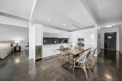 a kitchen and living room with a table and chairs at BOULAN HOTEL MIAMI BEACH BY IMD MIAMI 1BR/1BA UNIT in Miami Beach