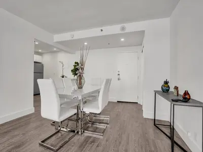 a white dining room with a white table and white chairs at Gorgeous Miami Beach Condo Beach Service 1614 in Miami Beach