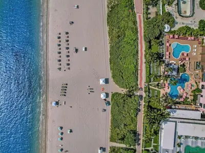 an overhead view of a beach next to the water at Gorgeous Miami Beach Condo Beach Service 1614 in Miami Beach