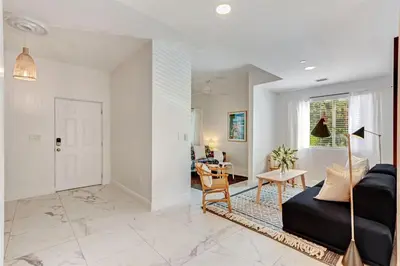 a living room with a couch and a table at Wynwood Jumbo - Sleeps 16 & free parking in Miami