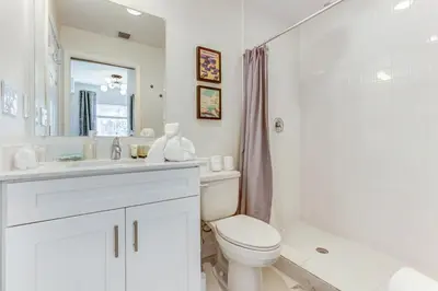 a bathroom with a toilet and a sink and a shower at Wynwood Jumbo - Sleeps 16 & free parking in Miami